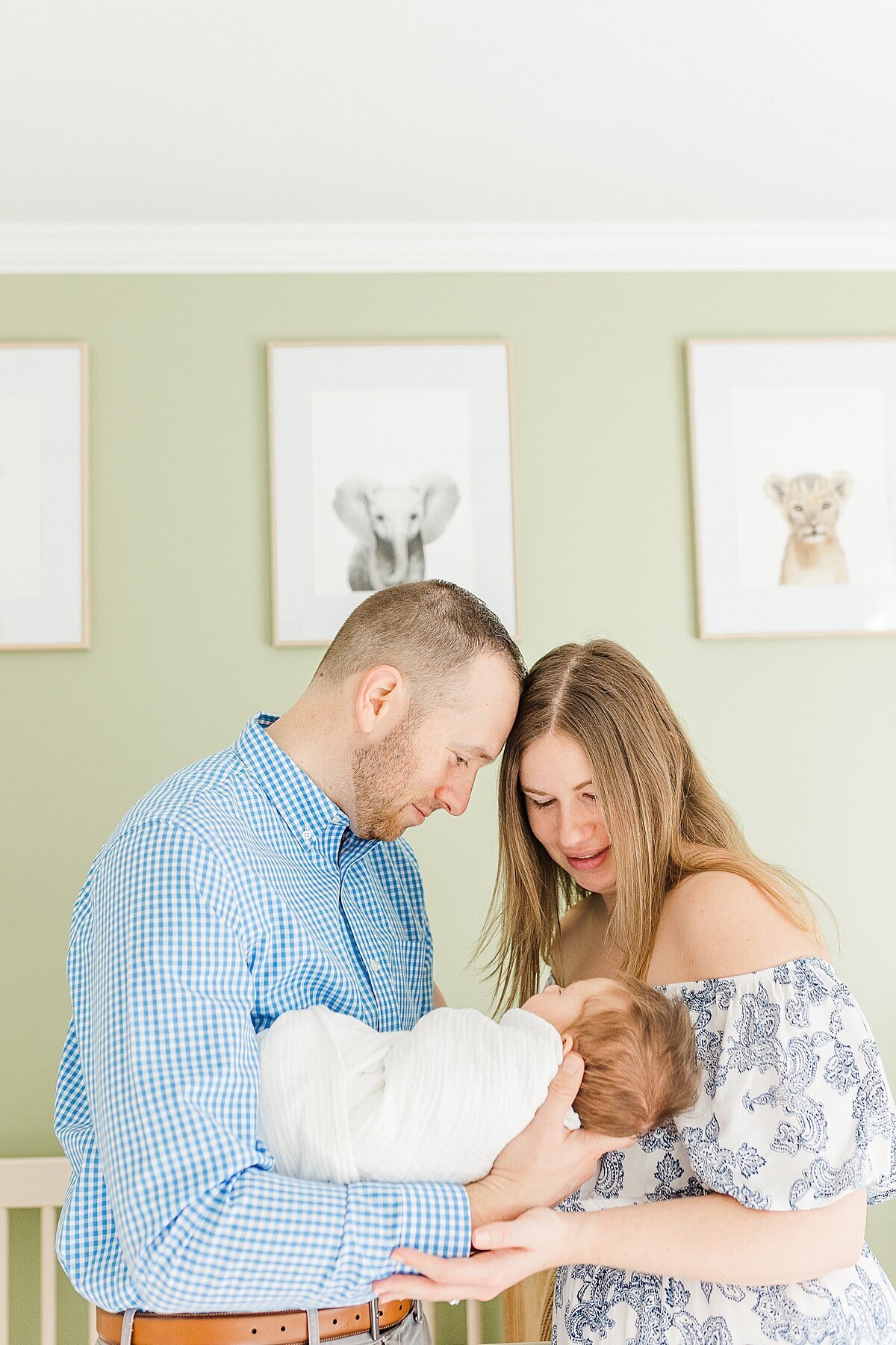 parents look at baby during in home newborn photo session with Sara Sniderman Photography  in Natick Massachusetts