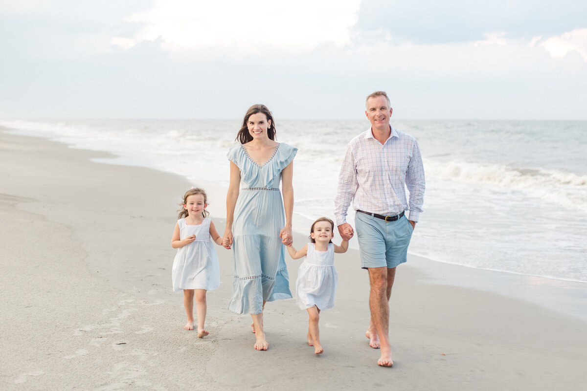 Family walks along Charleston beach for portrait session with Karen Schanely