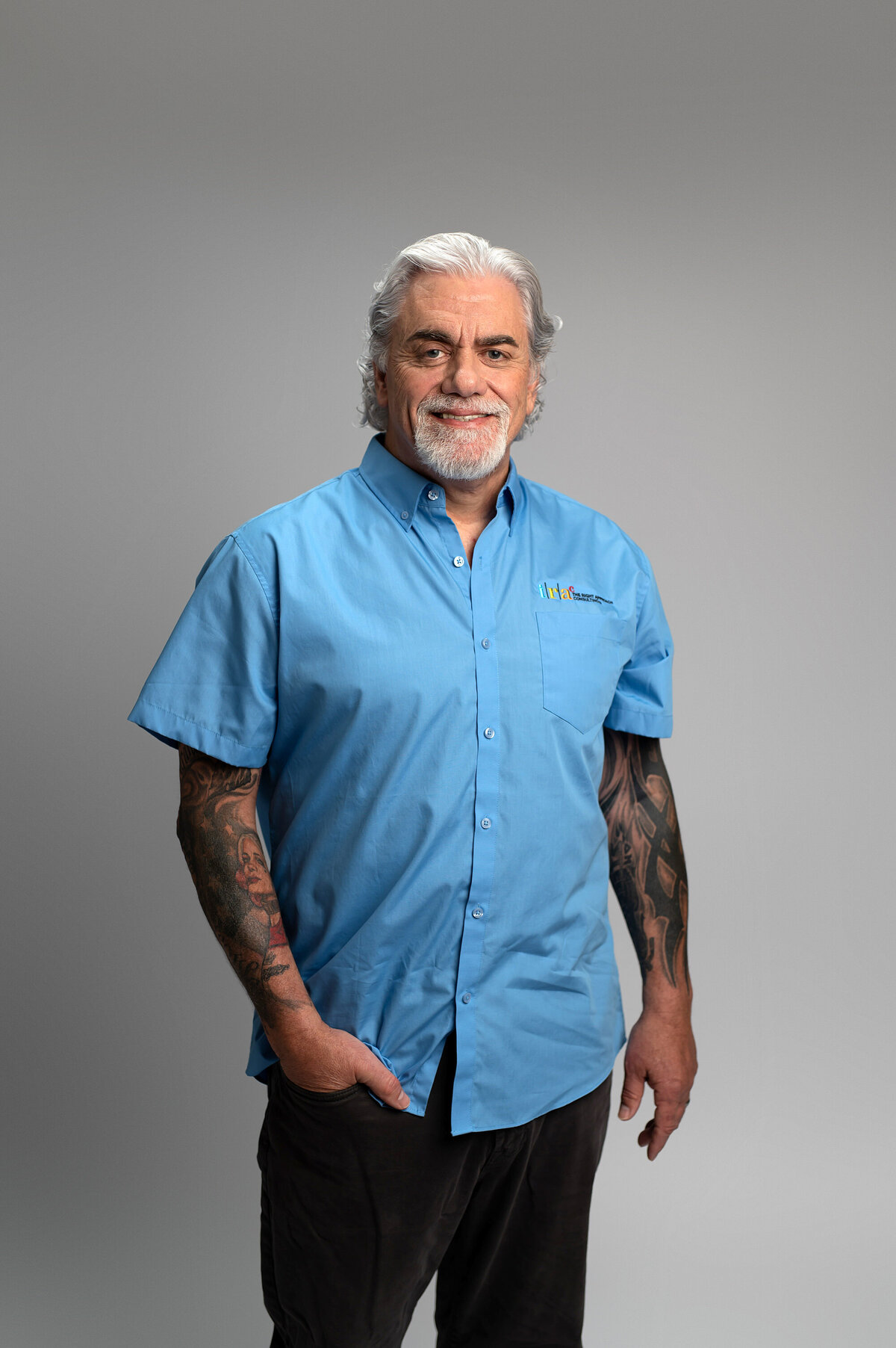 A Hartland, WI mechanic shows off his tattoo sleeves while having his professional headshots updated in our Waukesha portrait studio.