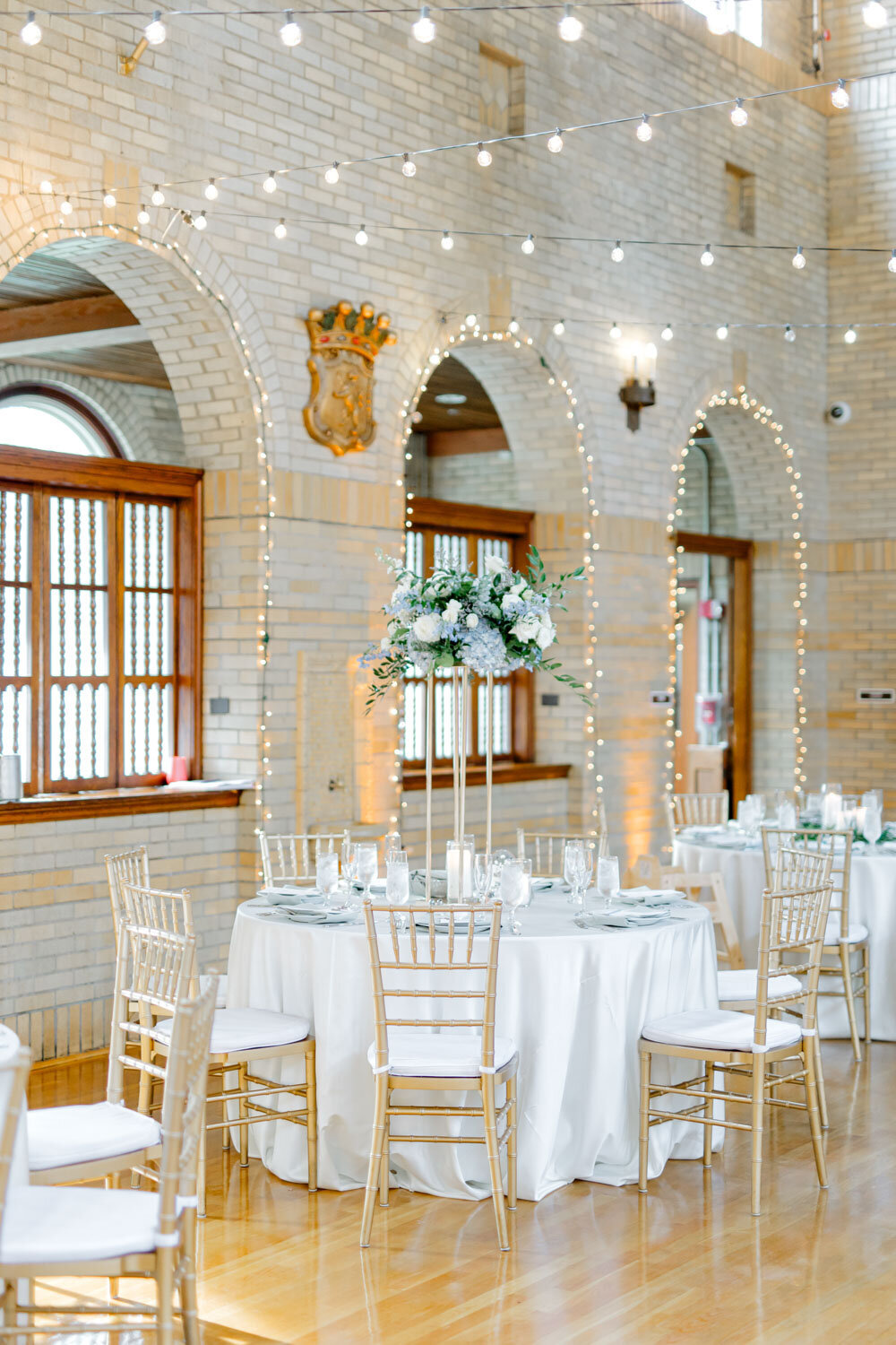 Reception hall with white brick arches and string lights