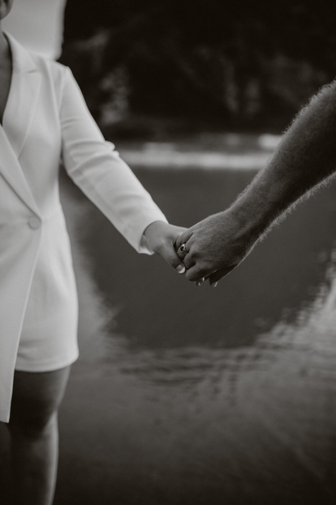 Editorial couple holding hands in black and white photo ont he beach Oregon.