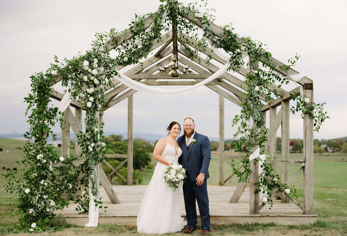 bridal and groom pose for their outdoor wedding at Sunny Slope Farm