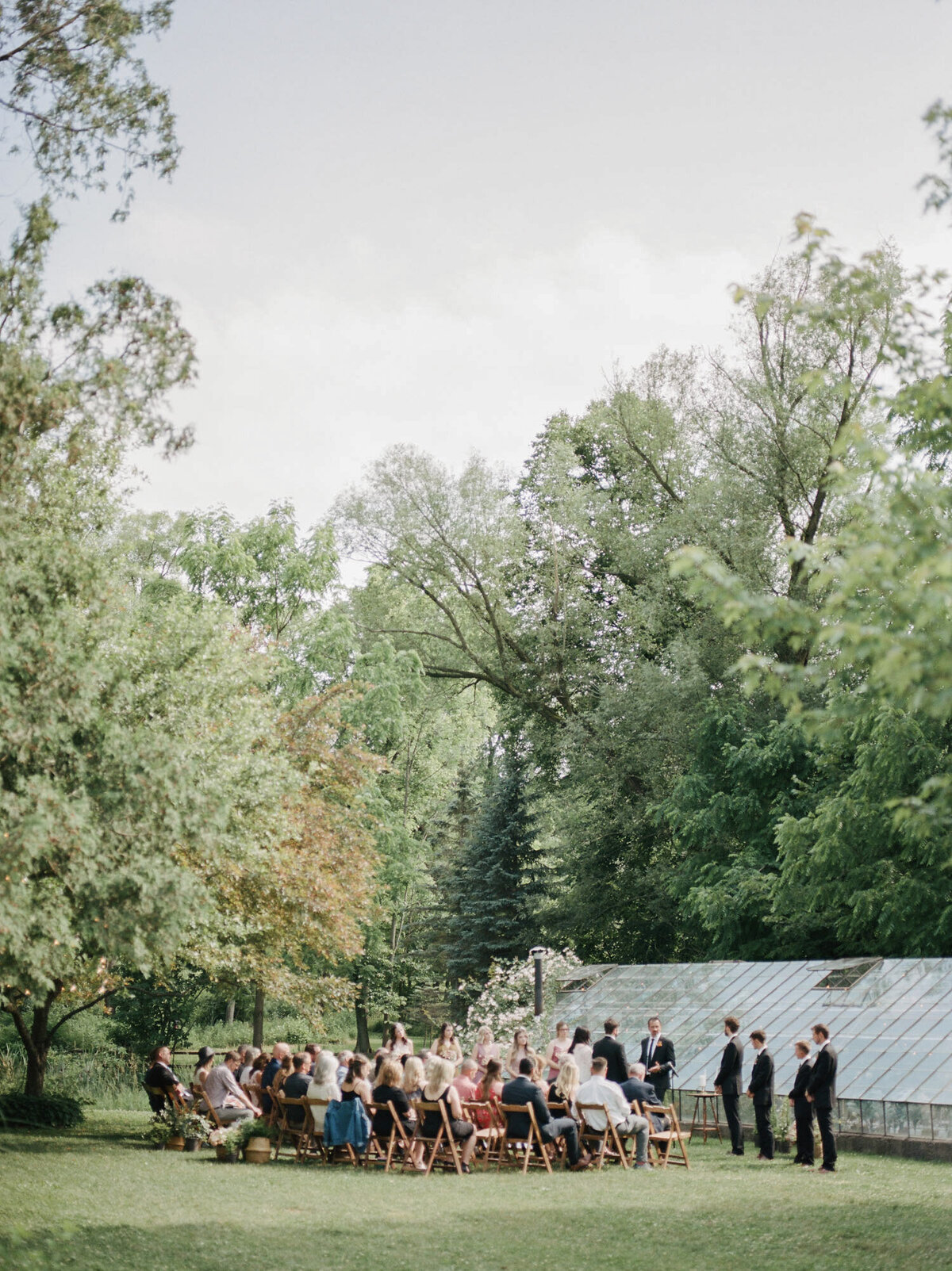 wedding ceremony at glass greenhouse in Michigan