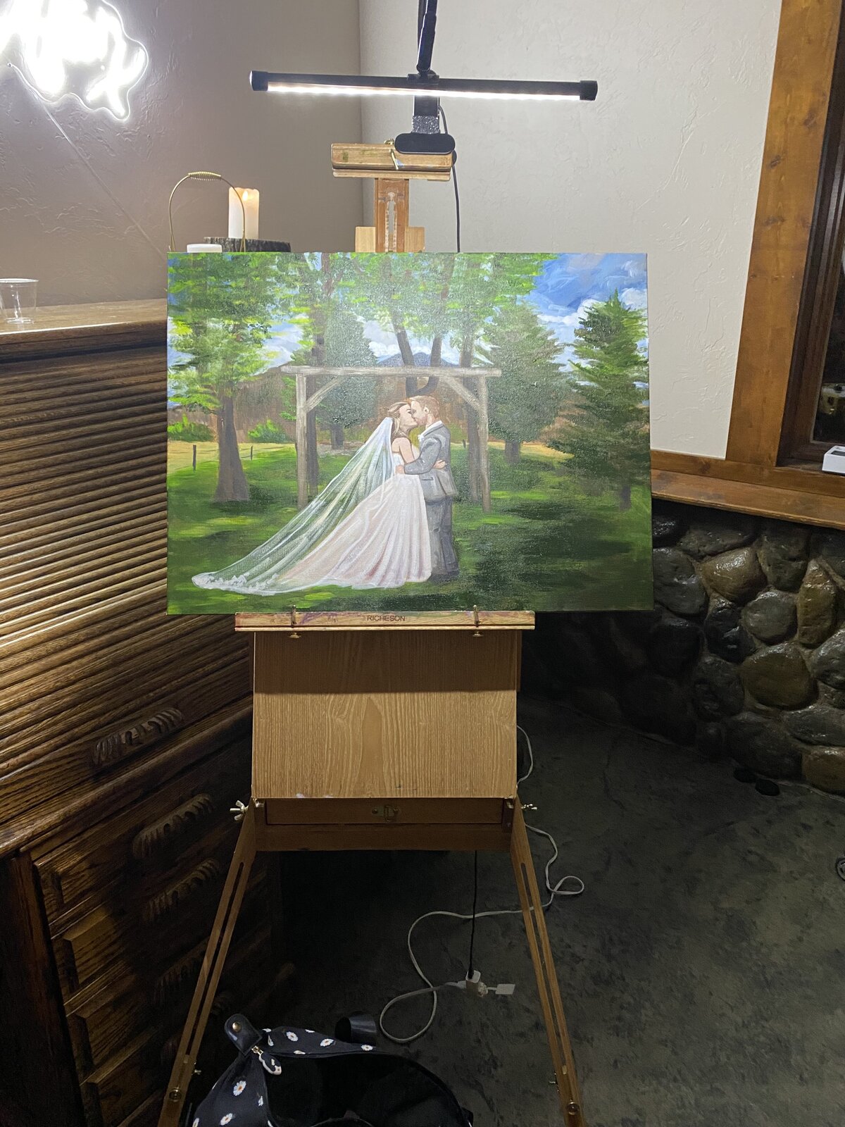 Progress shot of a first kiss live wedding painting