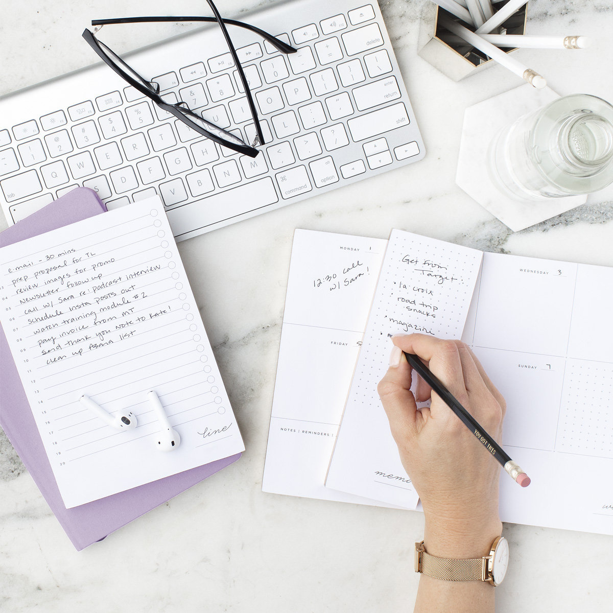 An image on The Purple Flamingo's Irresistible Content page depicting a desk with a keypad, pencils, and a diary, symbolizing the structured and strategic approach we use in content creation for small businesses.