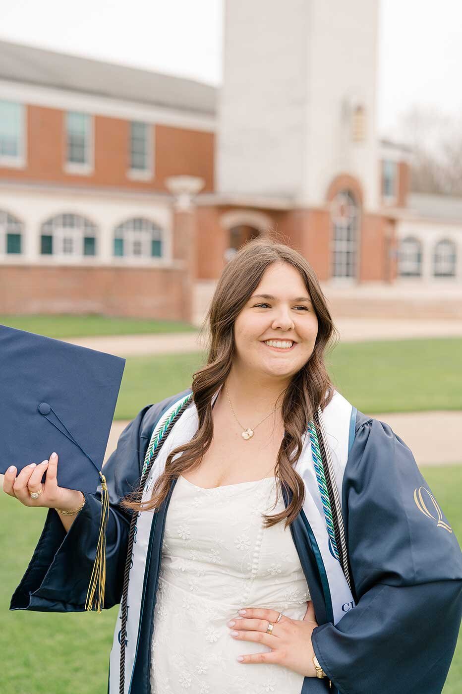 Brown hair girl poses in cap and gown