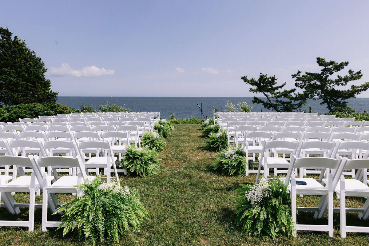 Wedding aisles with white chairs overlooking the sea at Cape Cod, Osterville, MA.