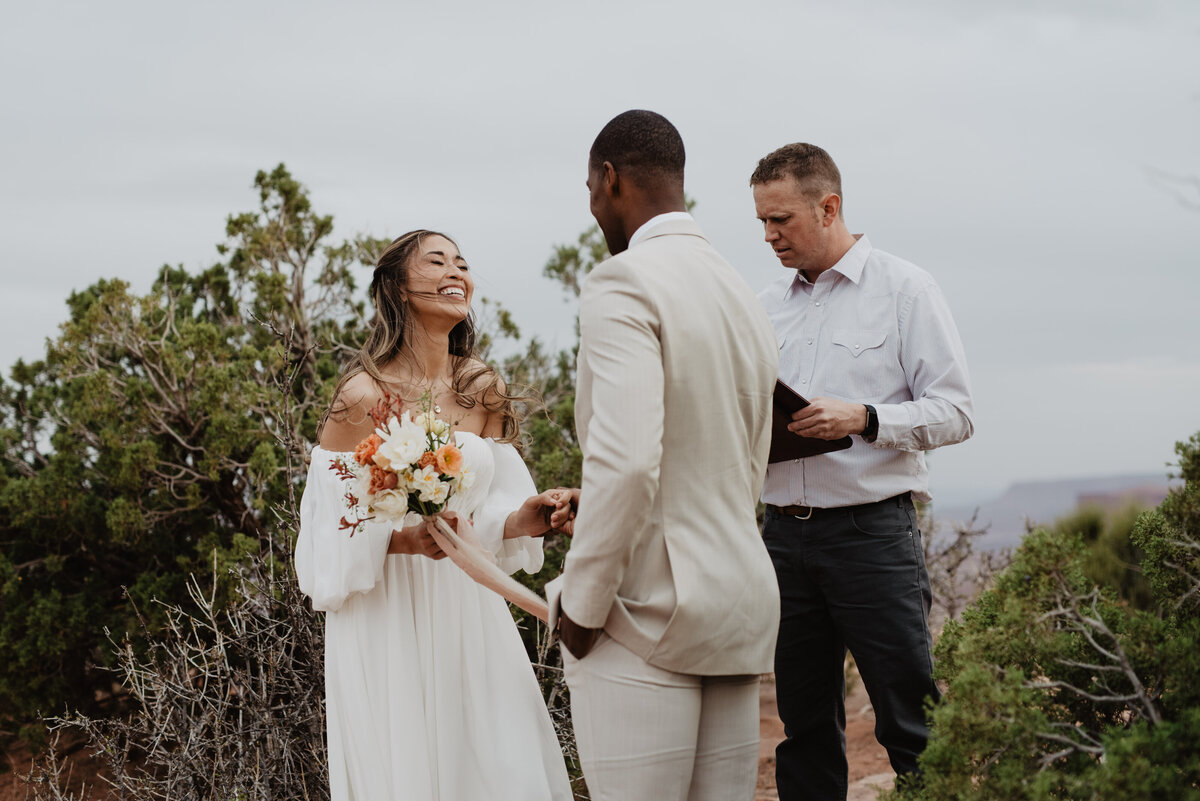 Utah Elopement Photographer captures bride smiling at groom during ceremony