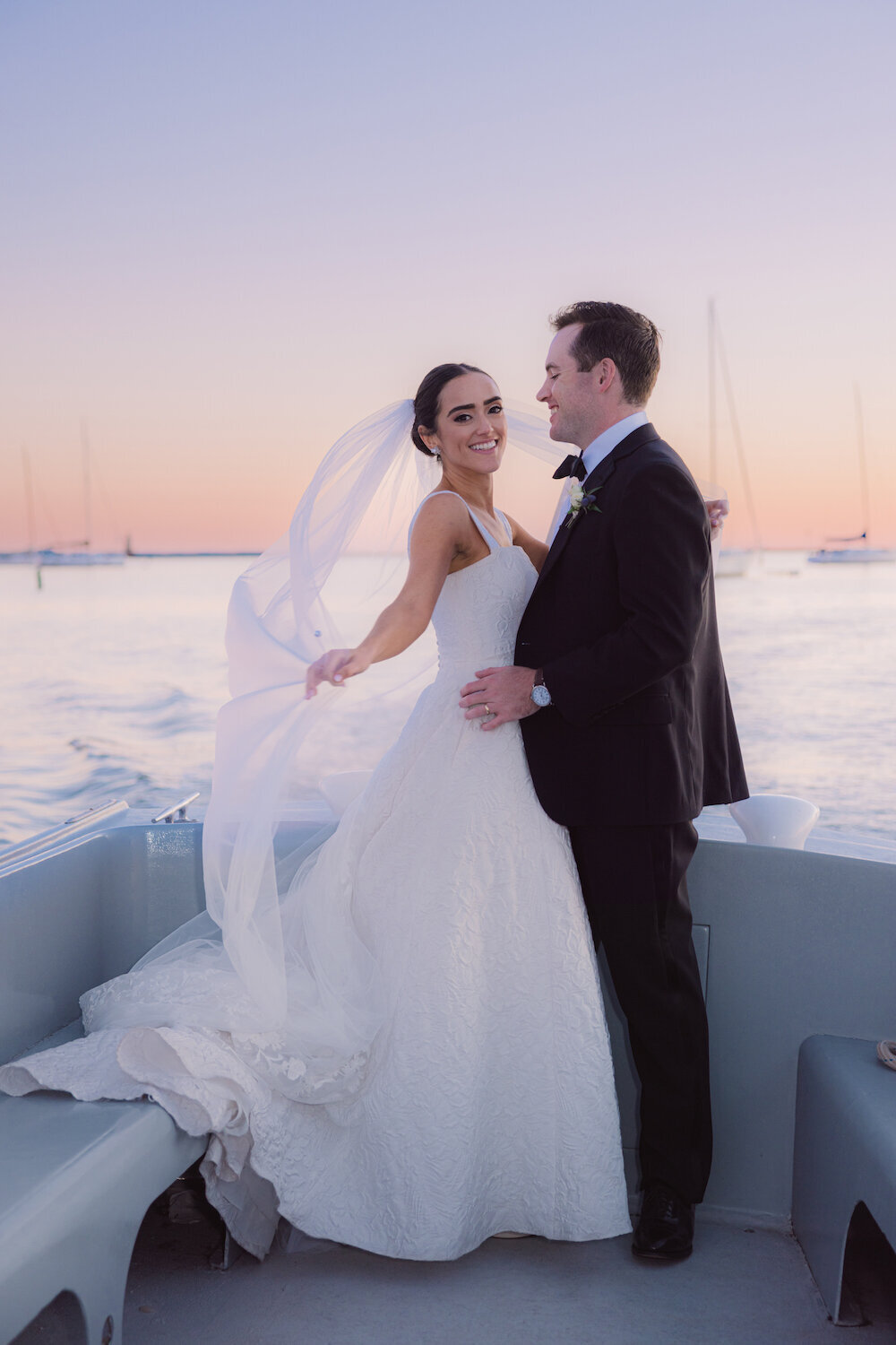 groom-bride-boat-wood-sailing-lela-rose-plumed-serpent-clermont-melrose-veil