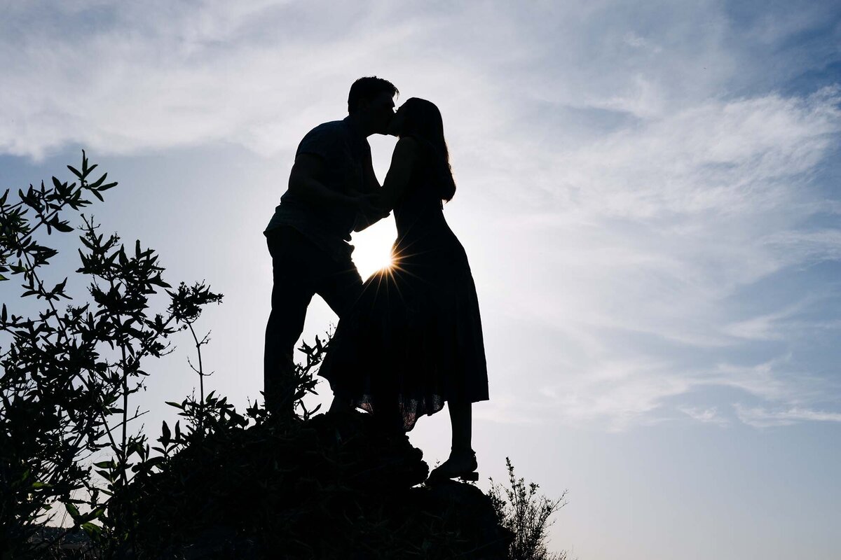 Silhouette Missoula couple kissing at dusk