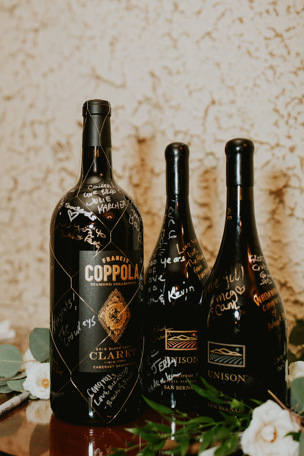 Wine bottles that guests signed