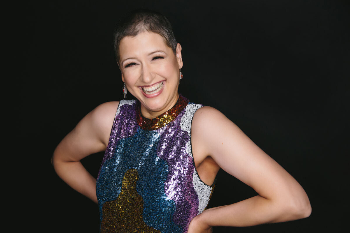 Woman of color posing for portrait wearing a sparkling tank top