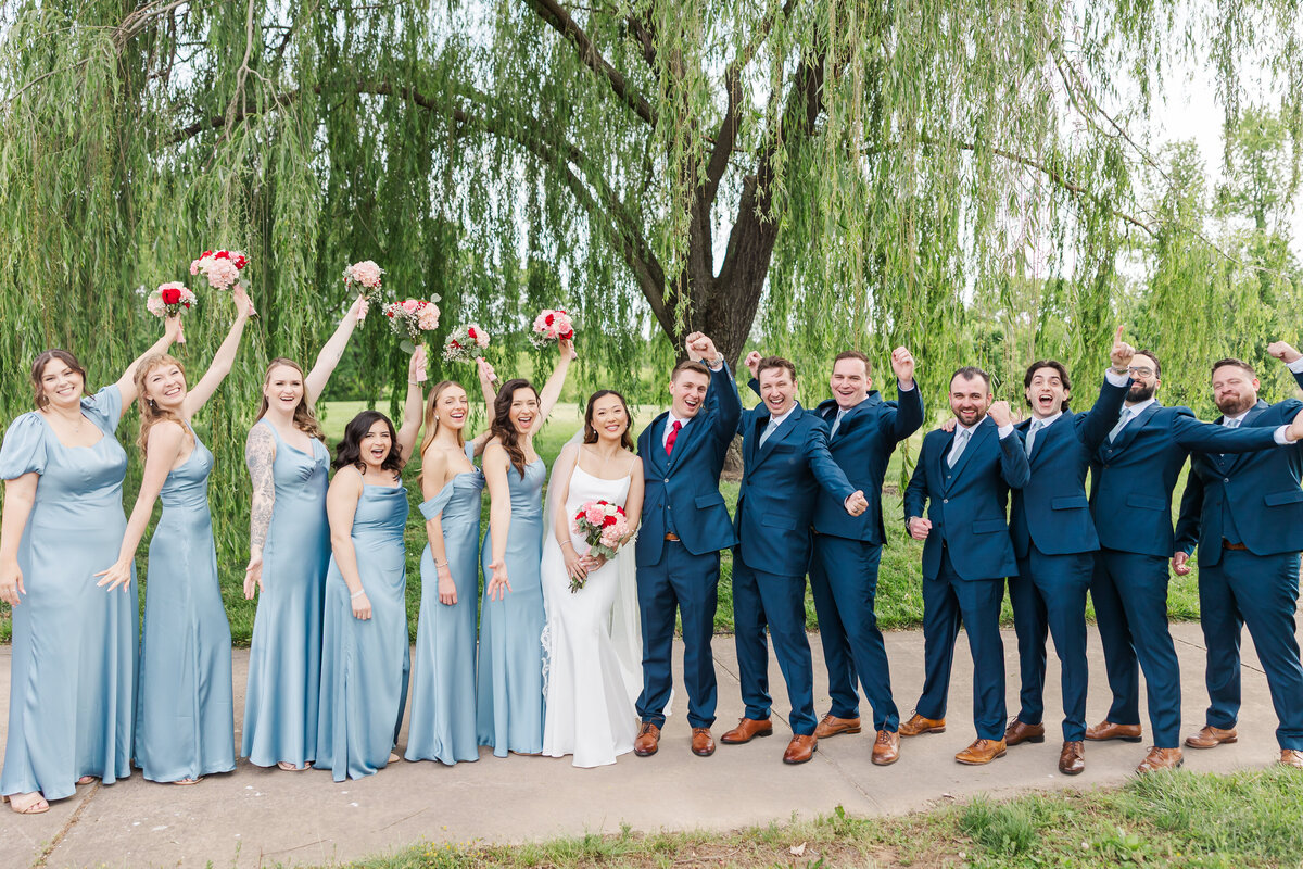 wedding party celebrating under the willow tree at the osprey's at belmont bay in virginia