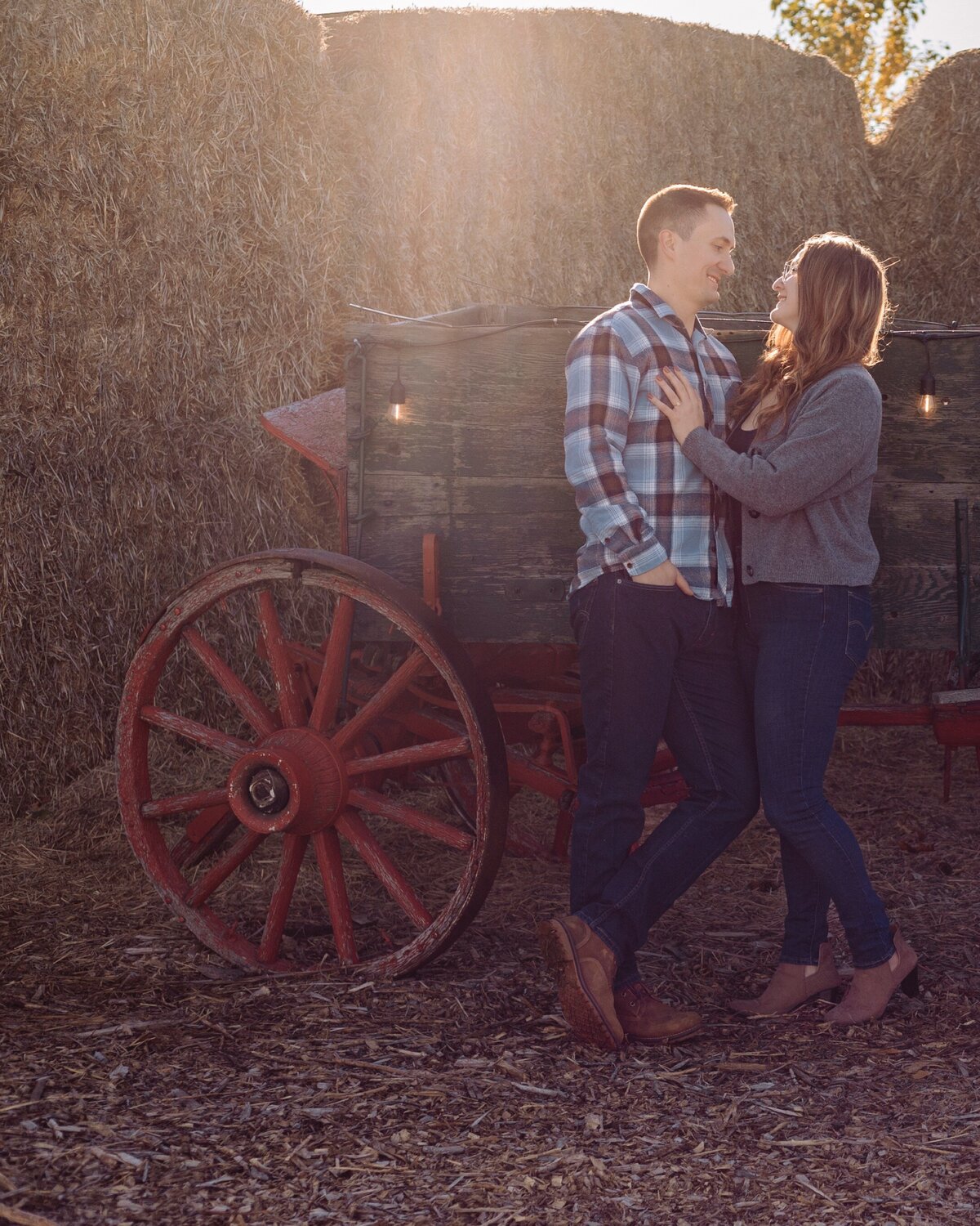 engaged-couple-lean-on-tractor