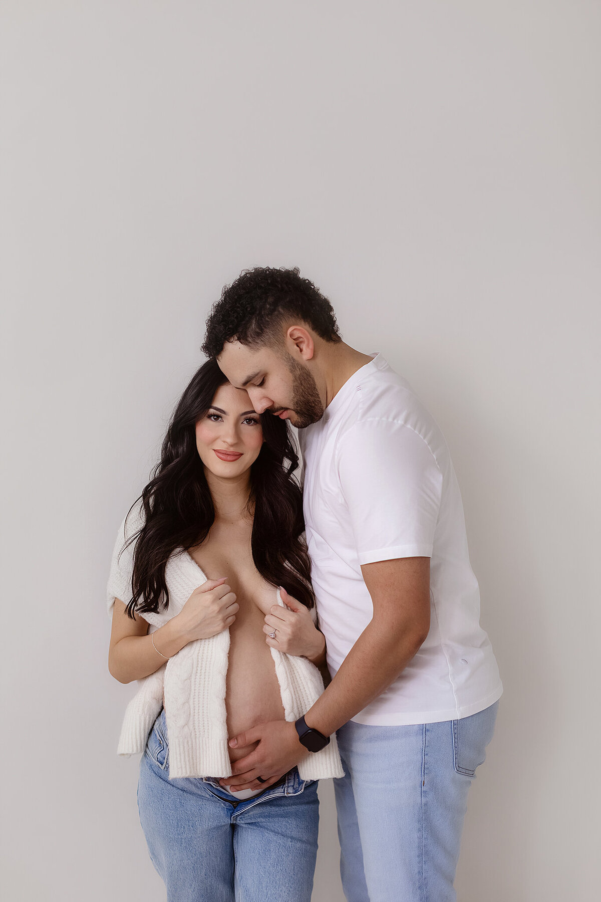 denver maternity photographer poses stunning couple in her studio for their pregnancy photos before baby arrives
