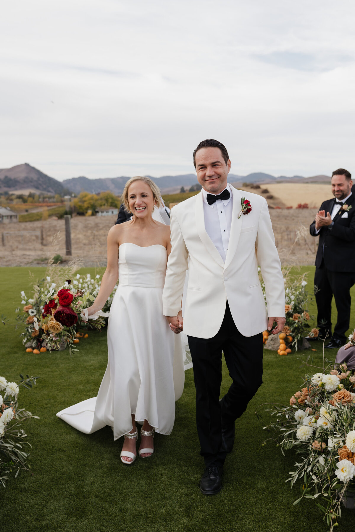 A stunning wedding moment captured at Carneros Resort in Napa Valley, featuring a bride and groom in golden vineyard light.