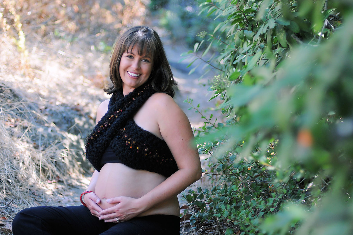 Mother holidng stomach in Southern California Maternity Photoshoot