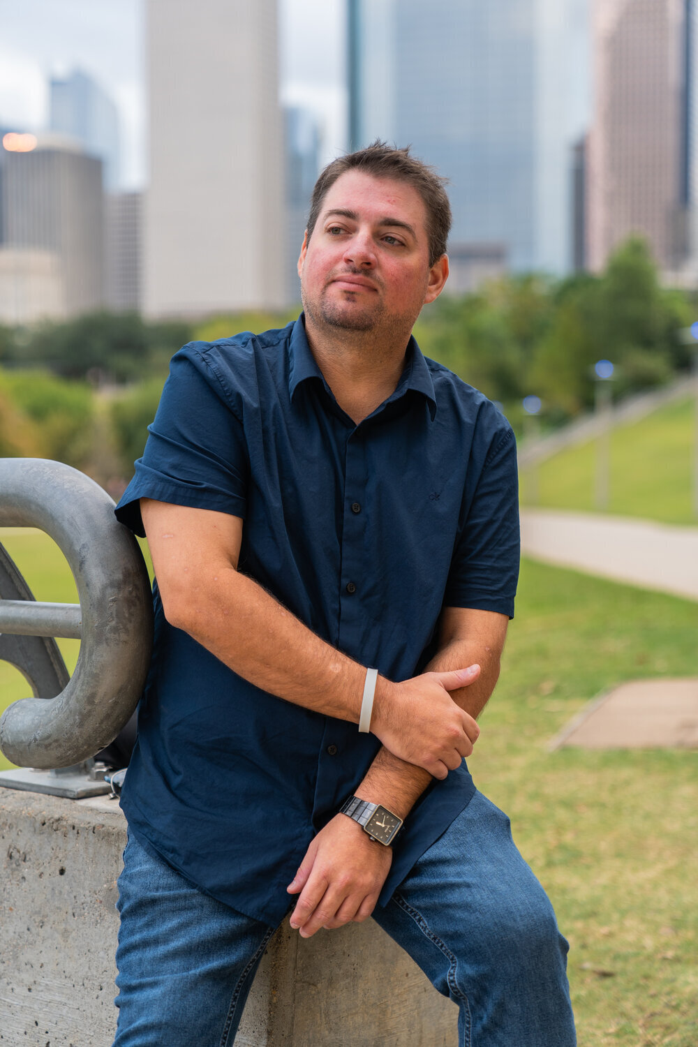 Tyler Frye posing in front of Downtown Houston for Houston freelance photographer