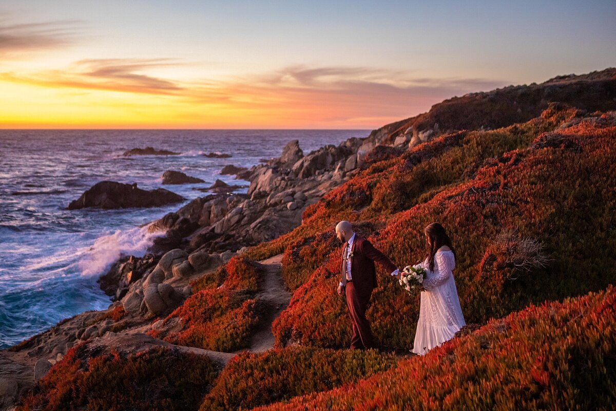 The bride and groom walk down to the cliffside for their Big Sur elopement