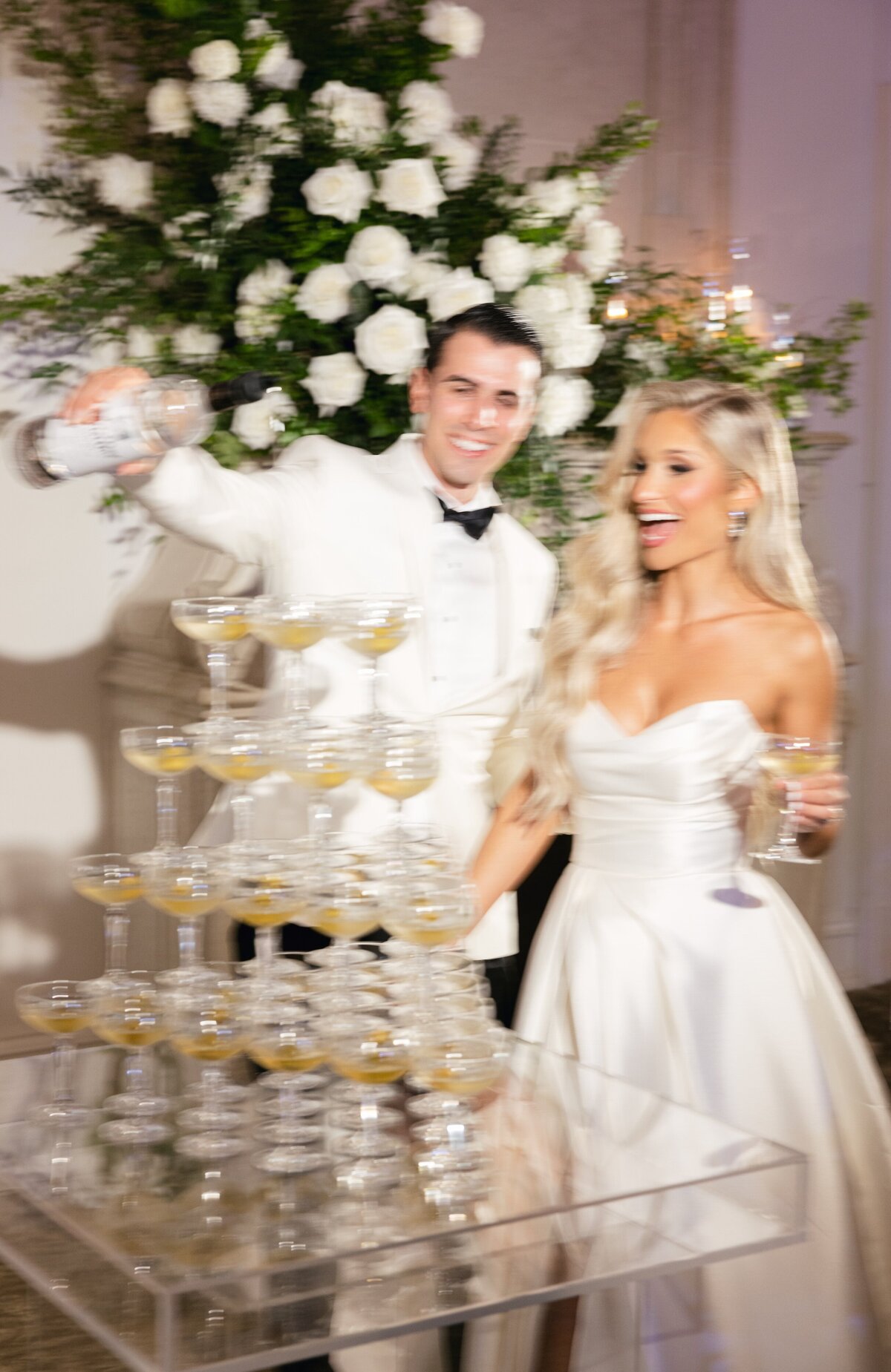Bride and groom sharing a champagne martini tower moment at their Park Château wedding reception in East Brunswick NJ