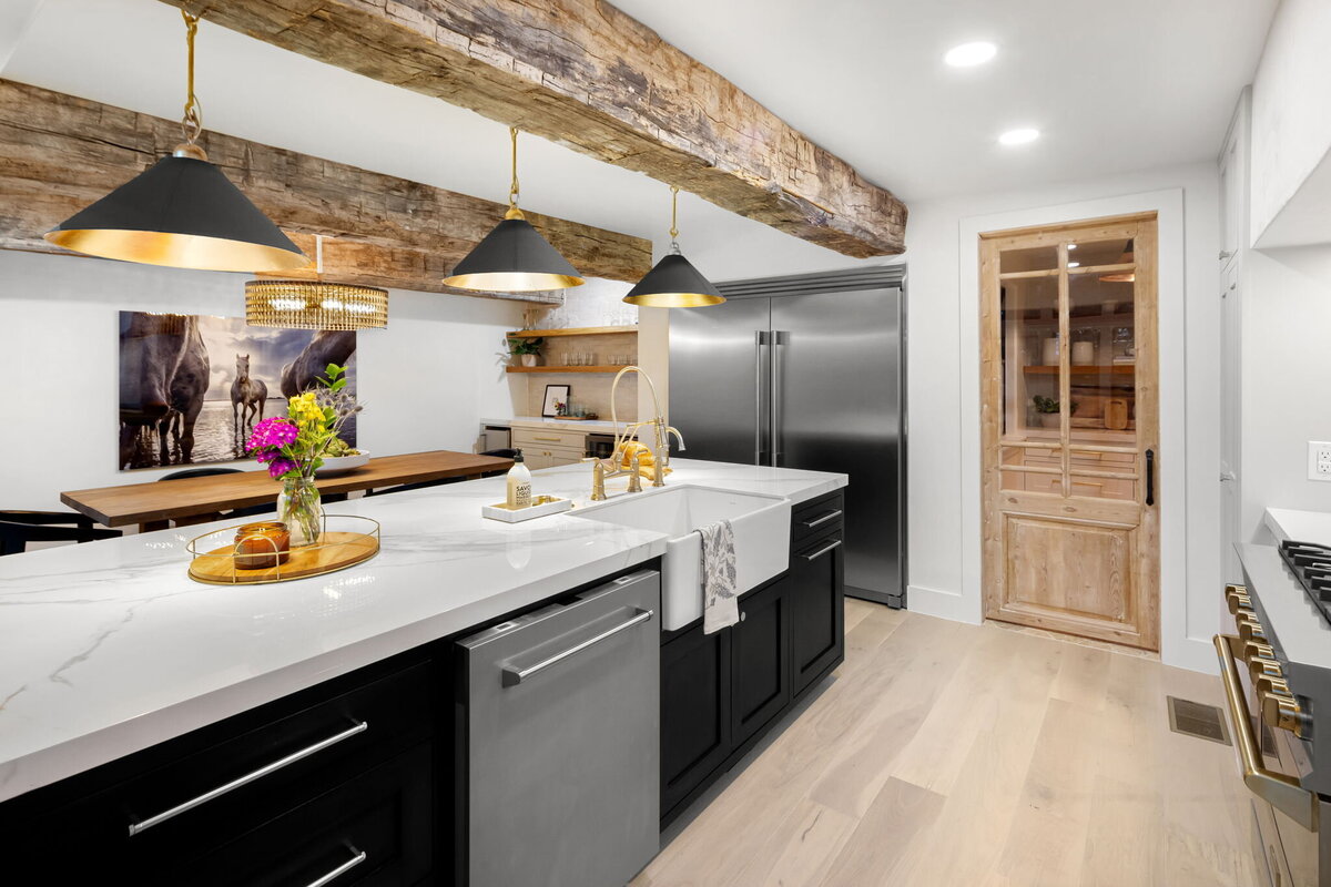 Kitchen island with marble and black and gold lampshades handing over island