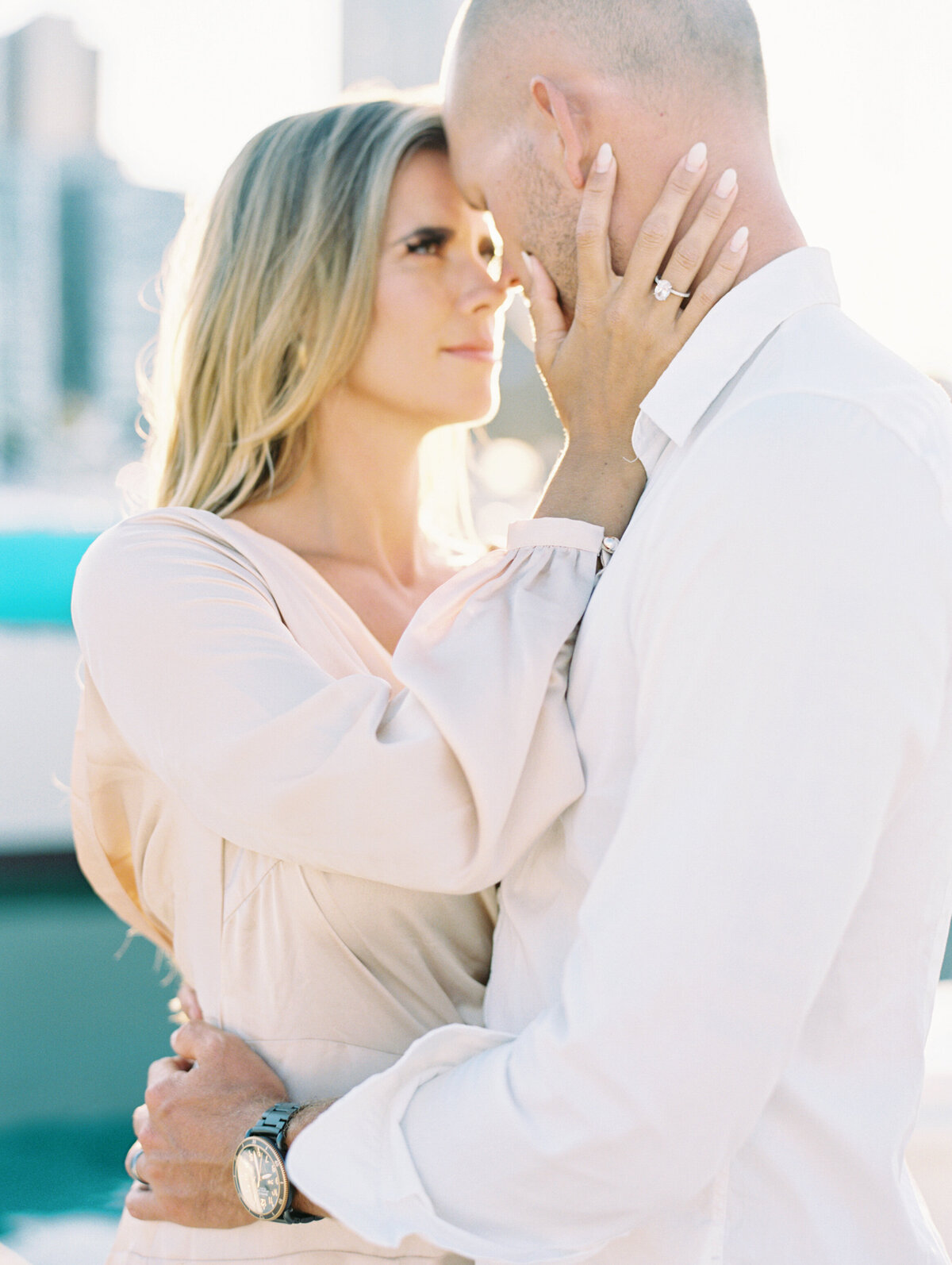 Bride and groom embracing on a saiboat in Chicago photographed by Arielle Peters Photography