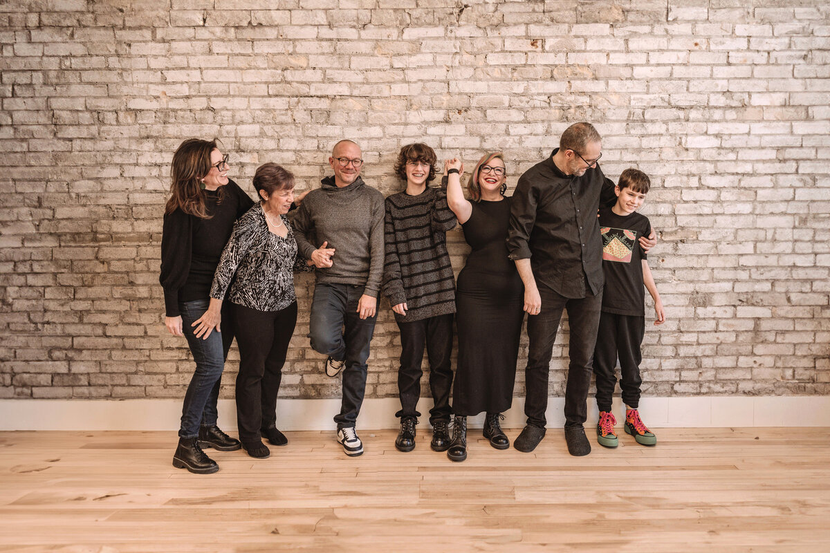 family against brick wall