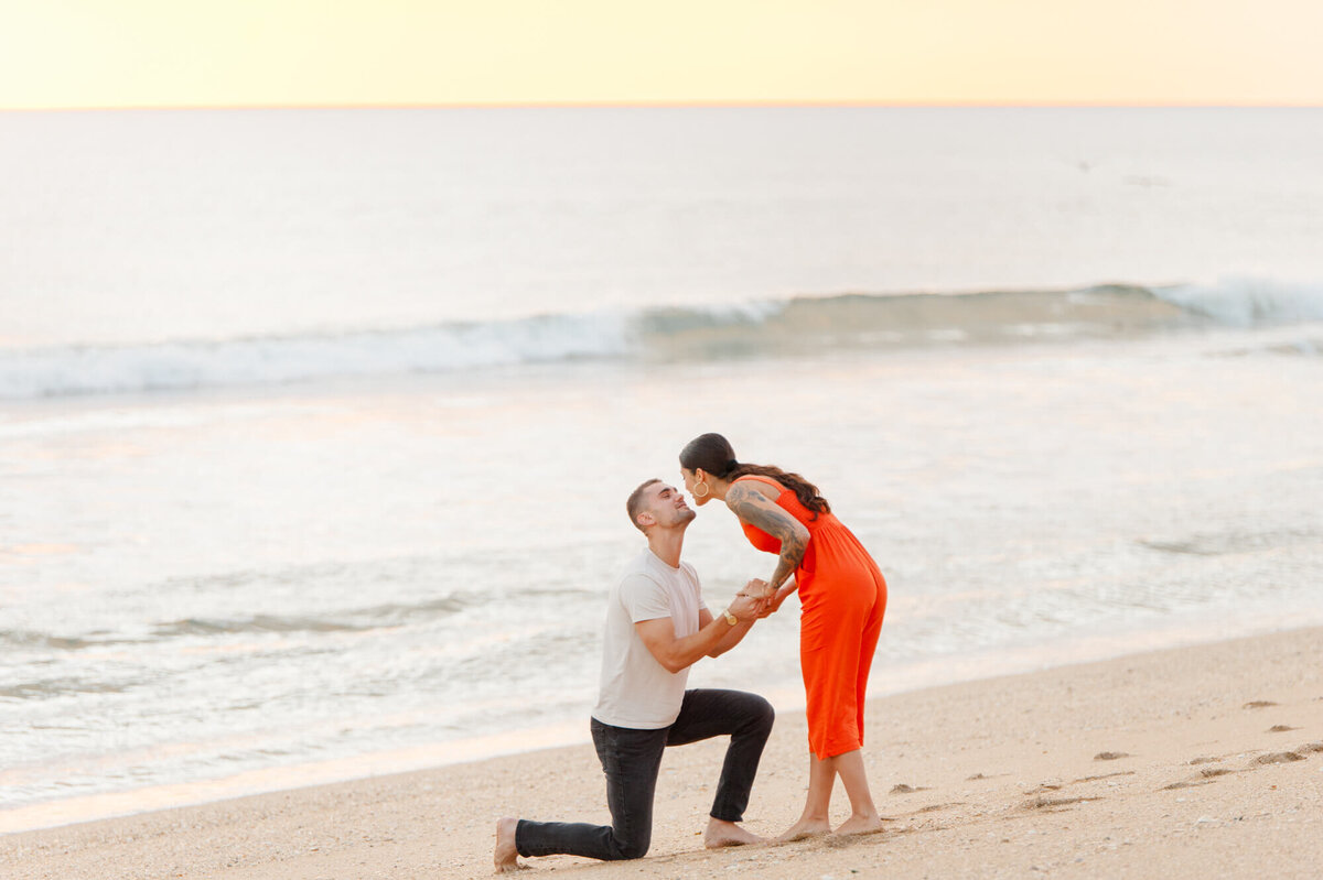 After proposing, couple goes in for a kiss at the beach east of Orlando
