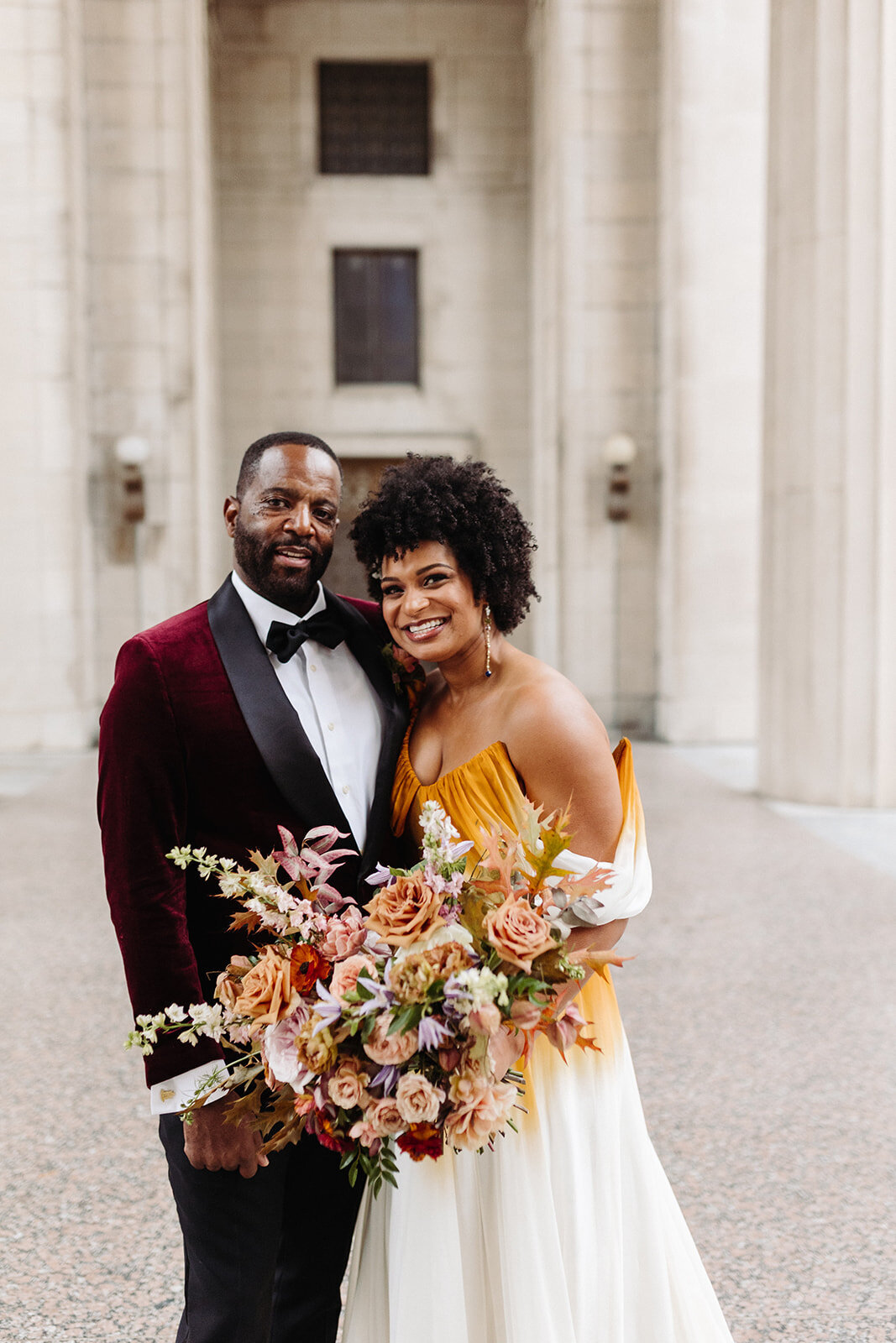 Beautiful autumnal bridal bouquet composed of roses, ranunculus, delphinium, clematis, lisianthus, and fall foliage floral hues of burnt orange, mauve, dusty rose, taupe, and lavender. Design by Rosemary and Finch in Nashville, TN.