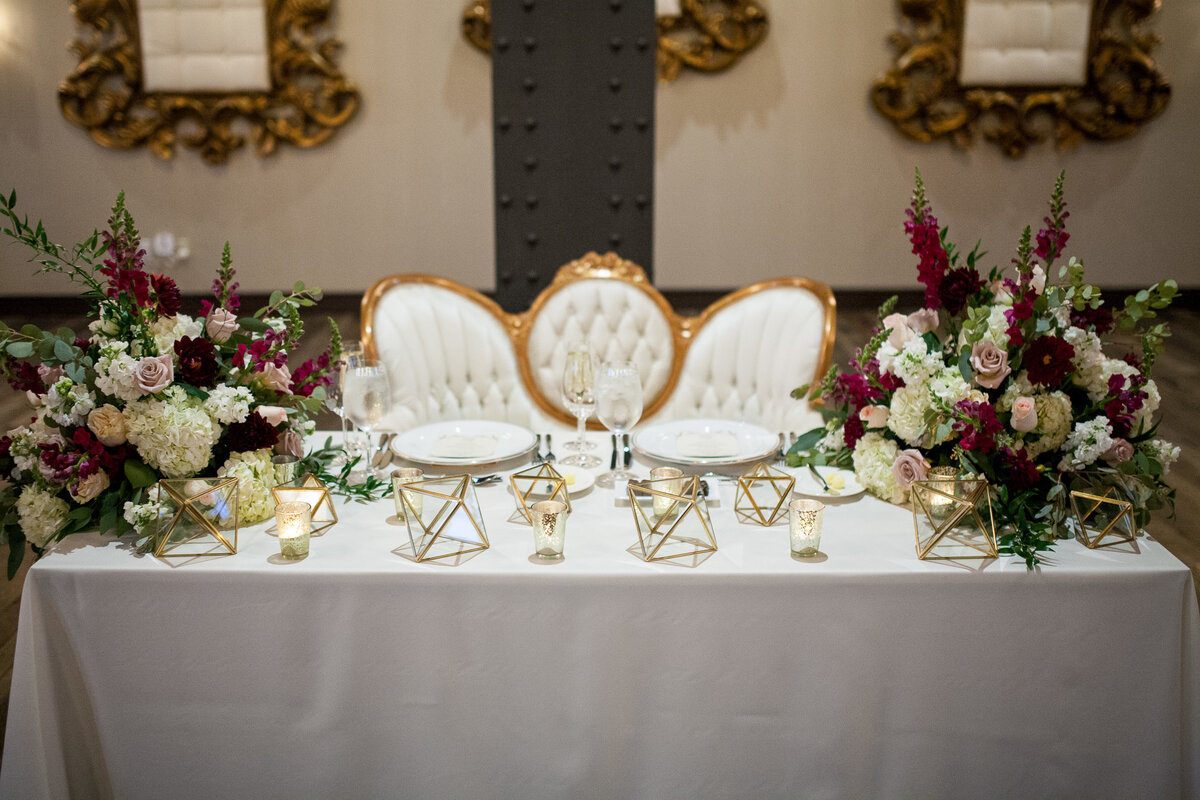 The bride and groom sat at this elegant and modern table setting at their wedding reception at Bissinger’s Caramel Room.