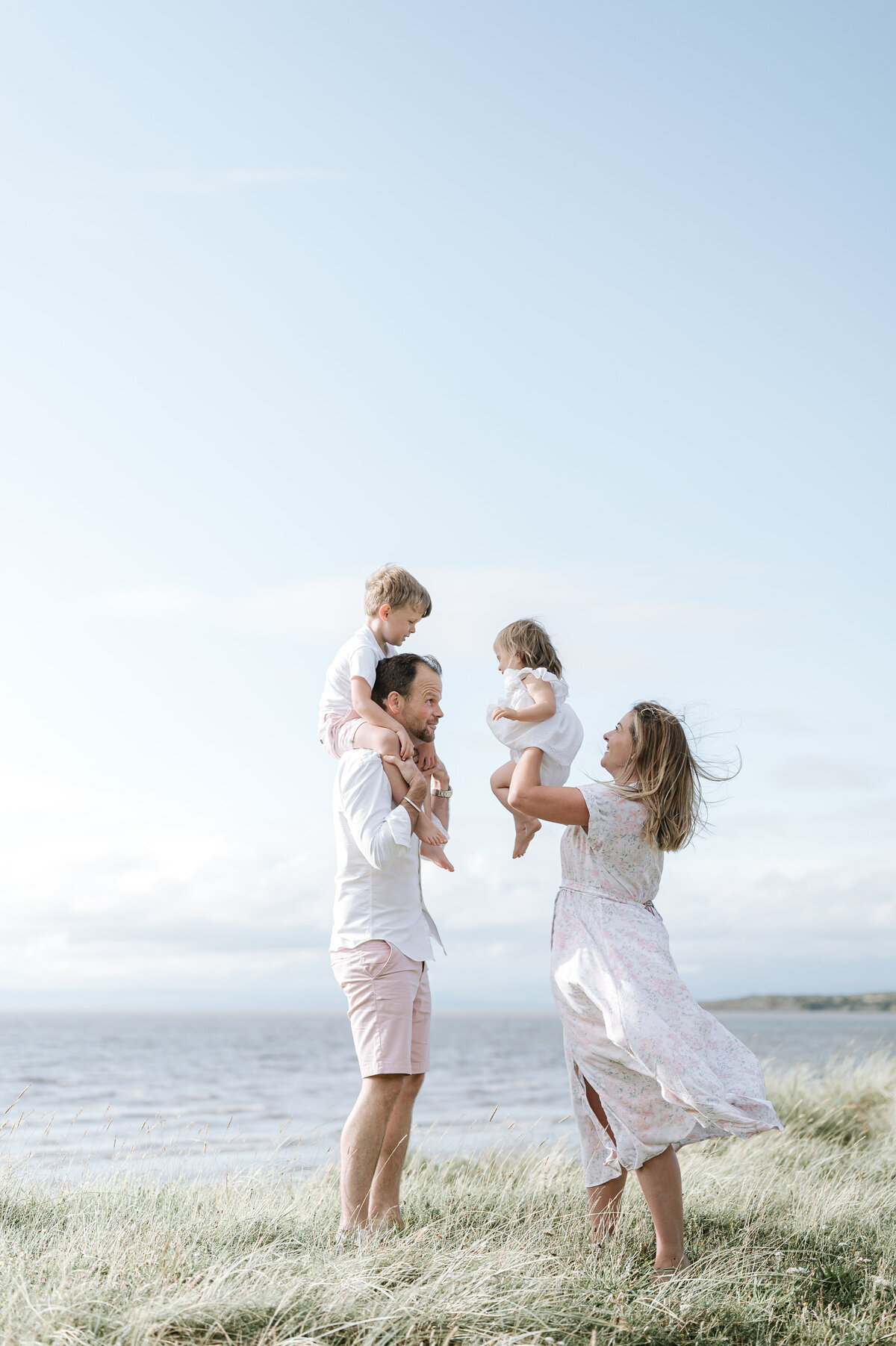 Bristol family photography of a mother and father with their children by the sea