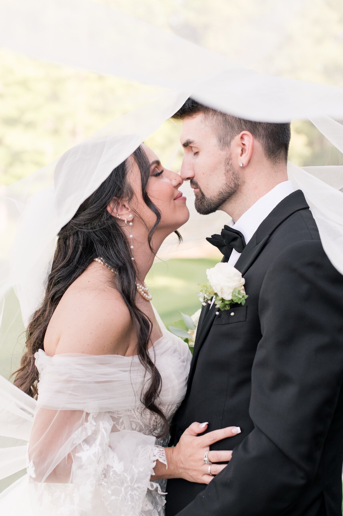 couple kissing under veil