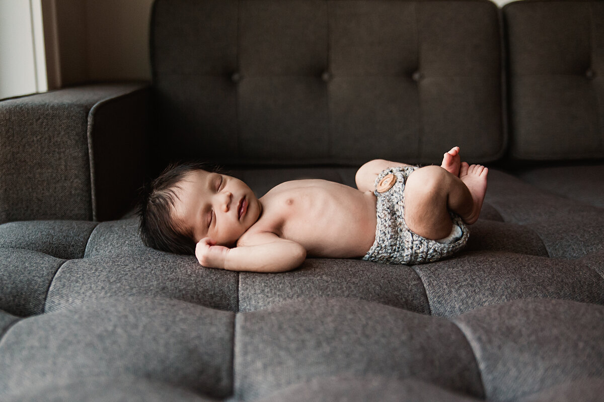 Baby boy sleeping on couch during his Toronto Newborn Photo session