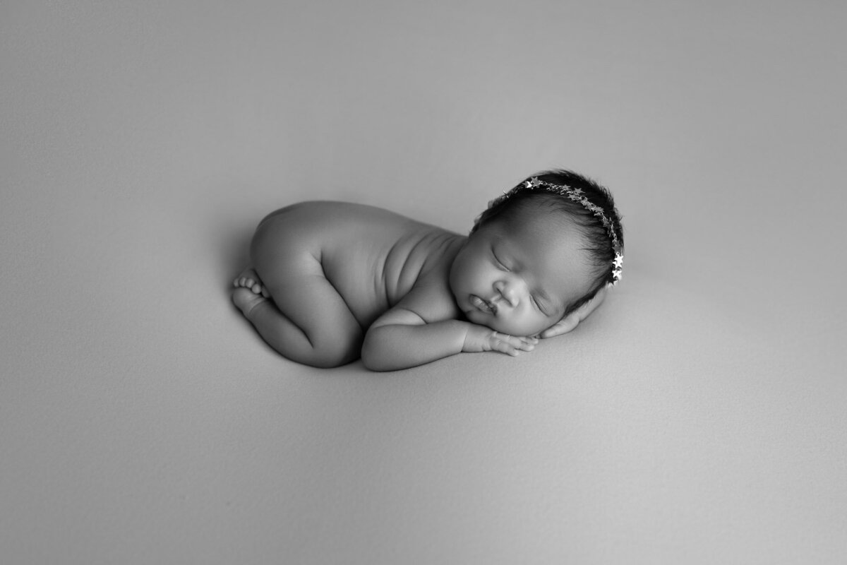 Black white newborn sleeping pose Lago Vista artistic baby photographer