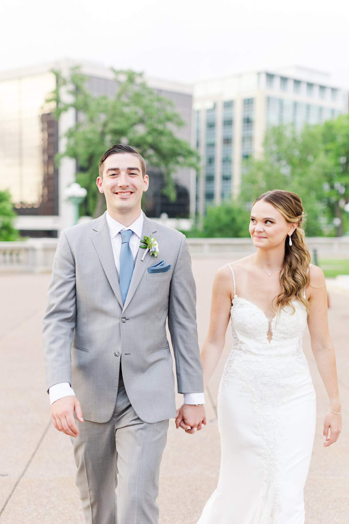 31_bride_and_groom_walking_holding_hands_madison_state_capitol_building