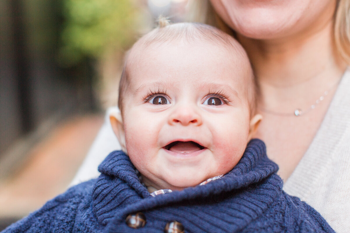 baby boy with long eyelashes smiling at camera