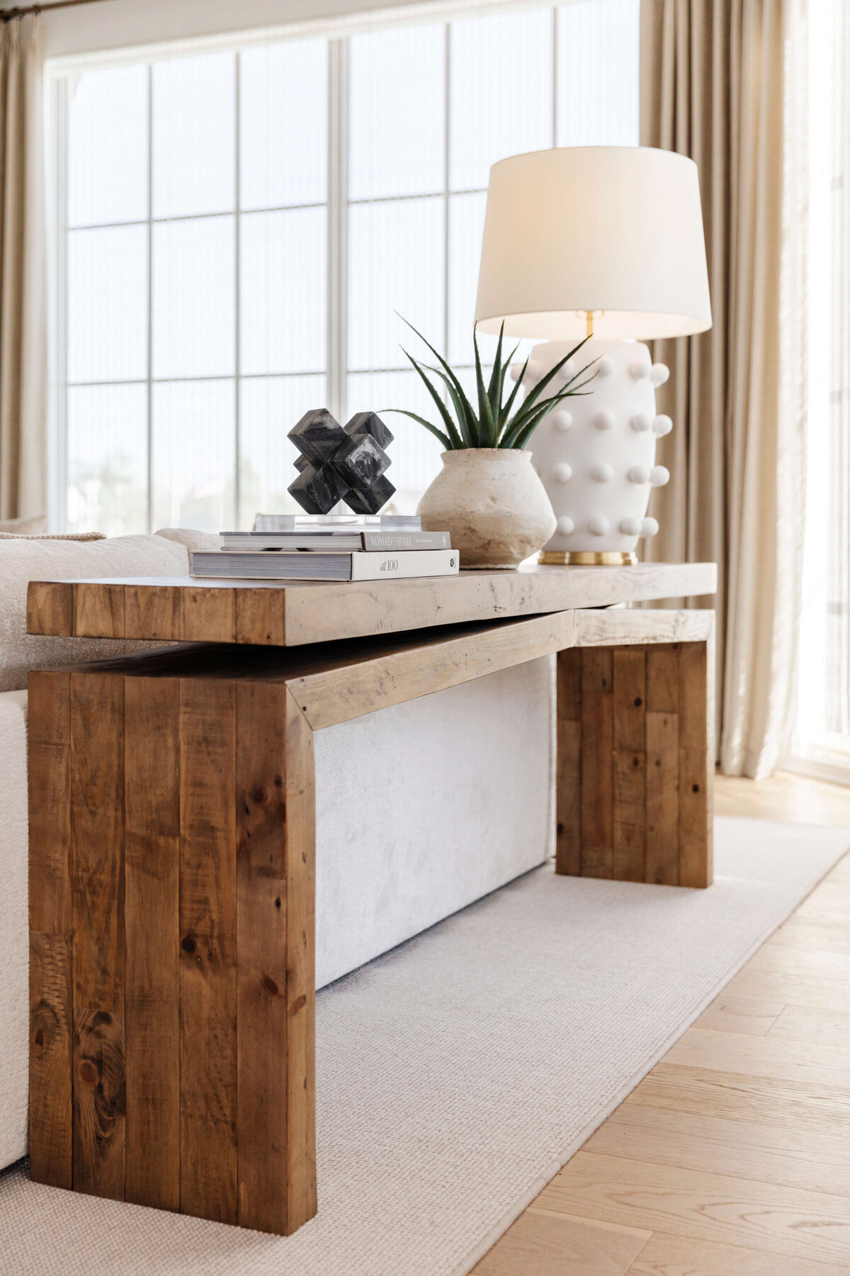 oyster creek studios hughes angular wooden side table with white lamp in living room