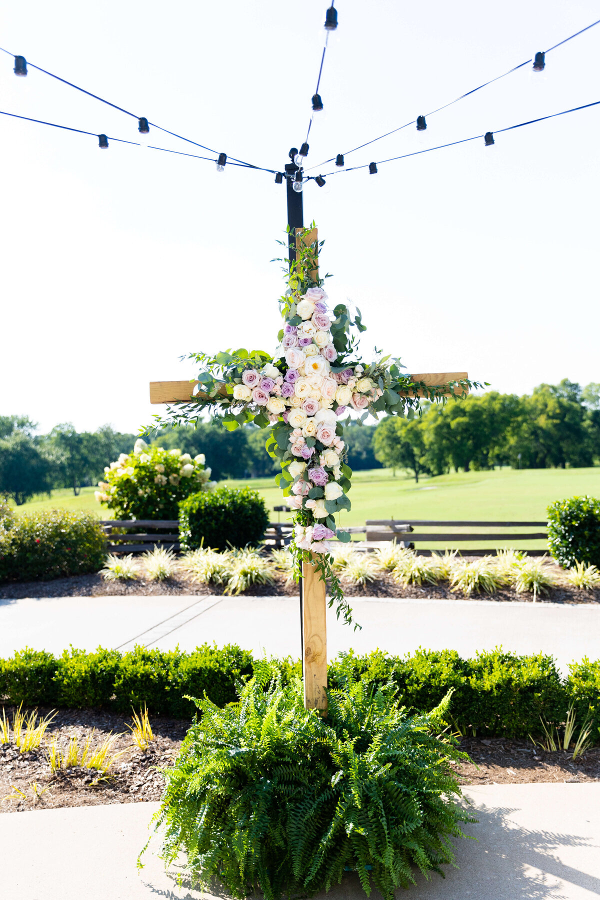 Wedding ceremony cross decorated with florals for wedding at Stones River Country Club