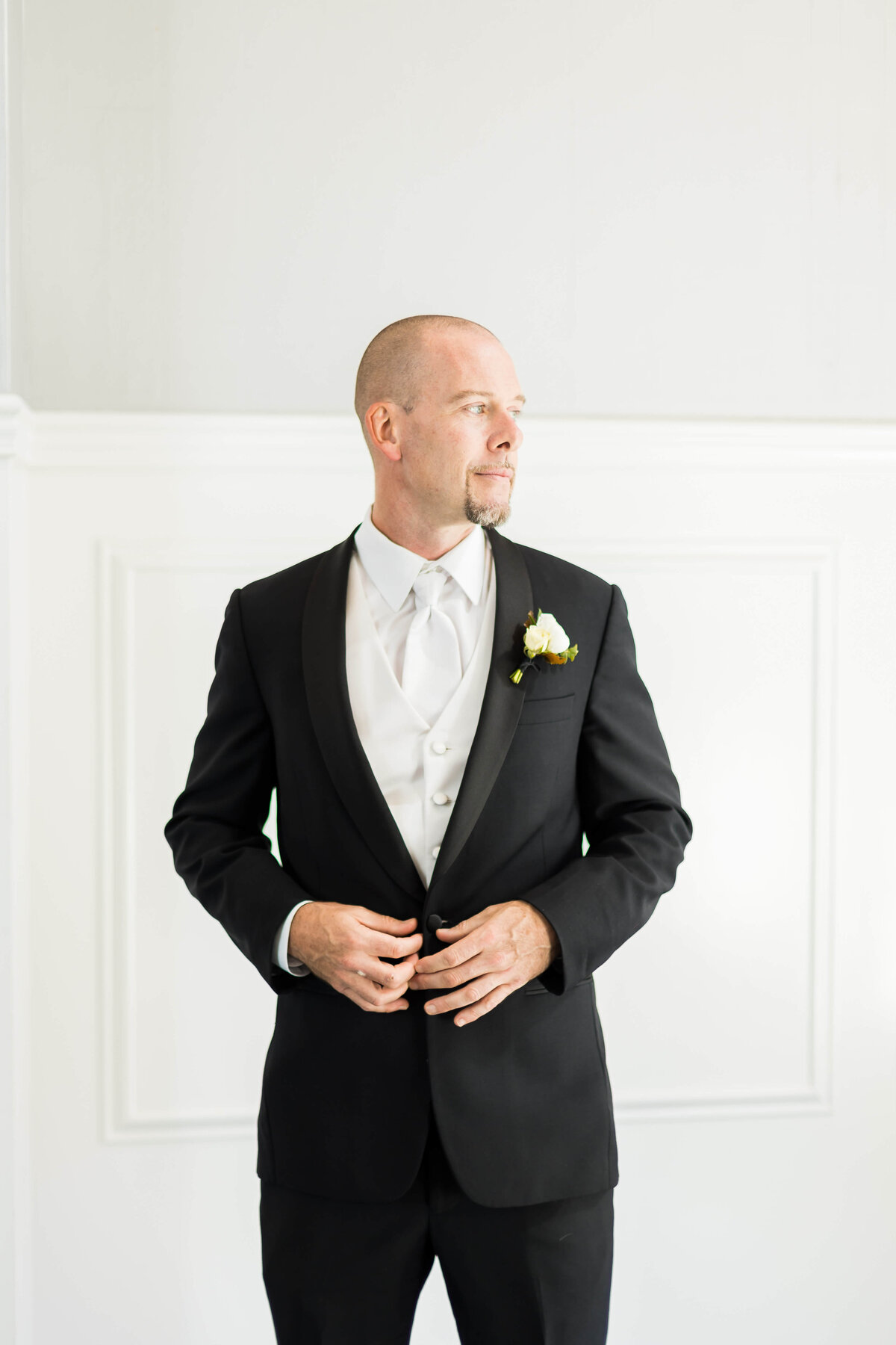 Groom buttoning suit at The Carrick House Wedding venue in Lexington, KY