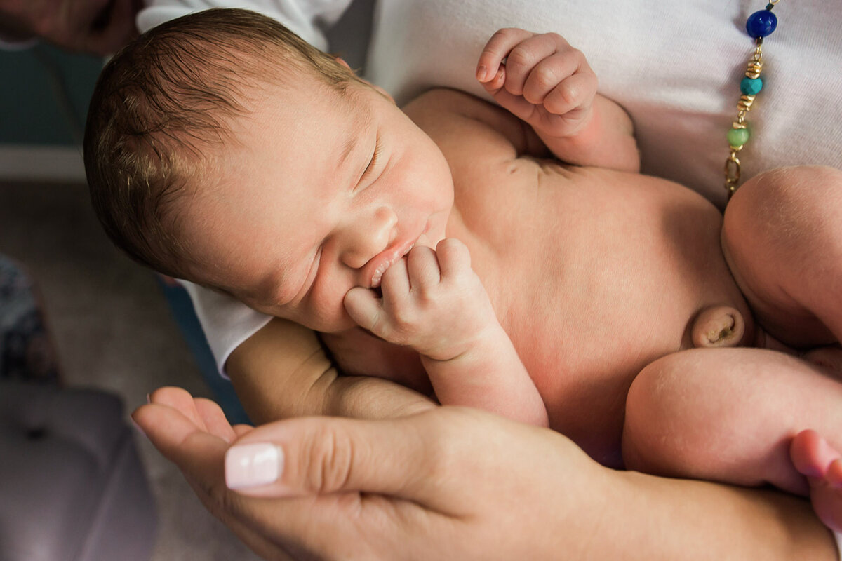 lifestyle newborn mom holding baby-1