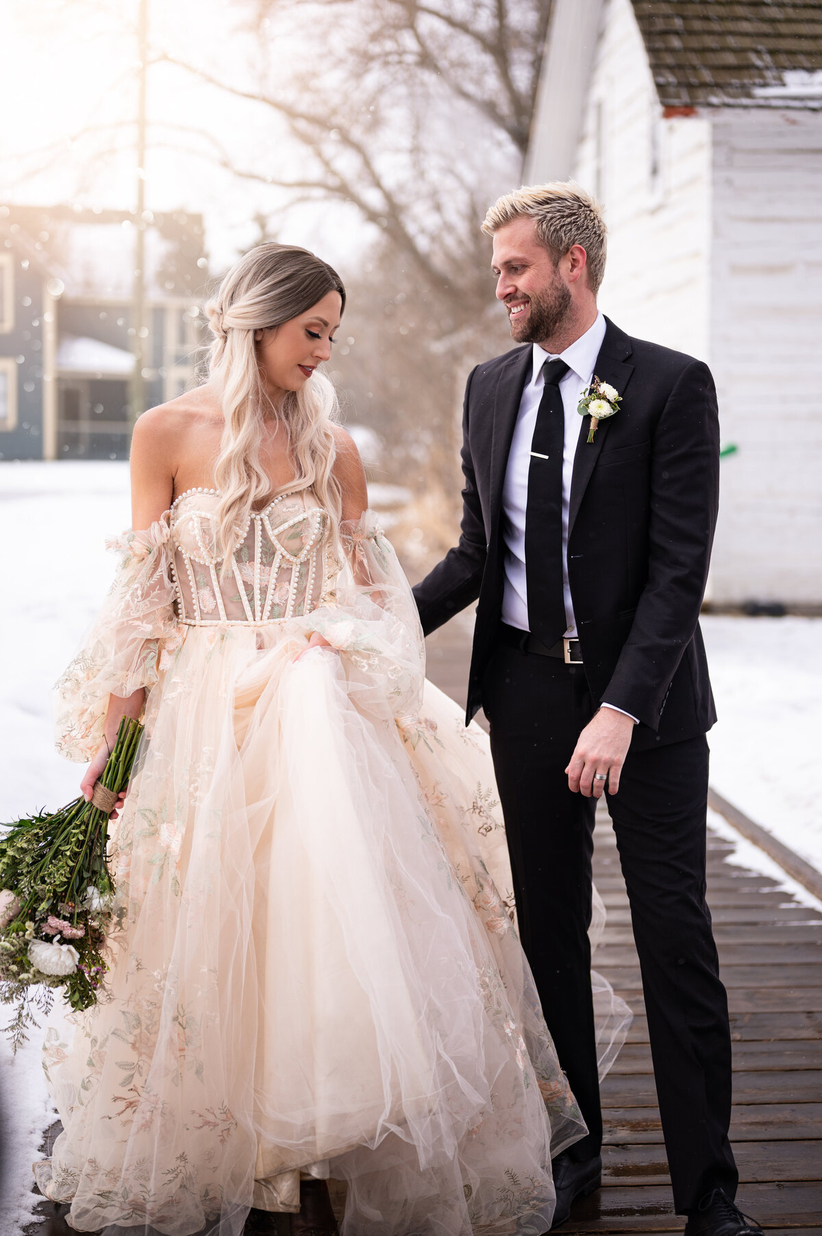 married couple looking at each other and smiling for their wedding portaits