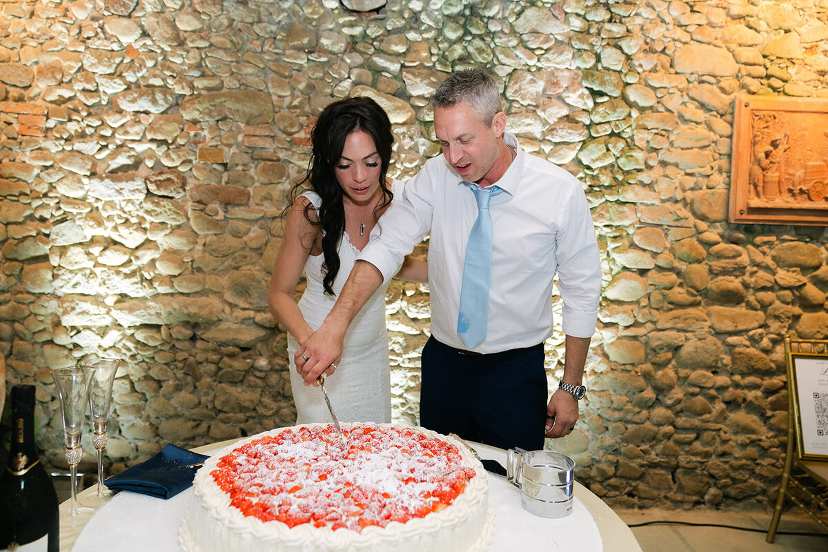 Bride and groom cutting a modern Italian wedding cake