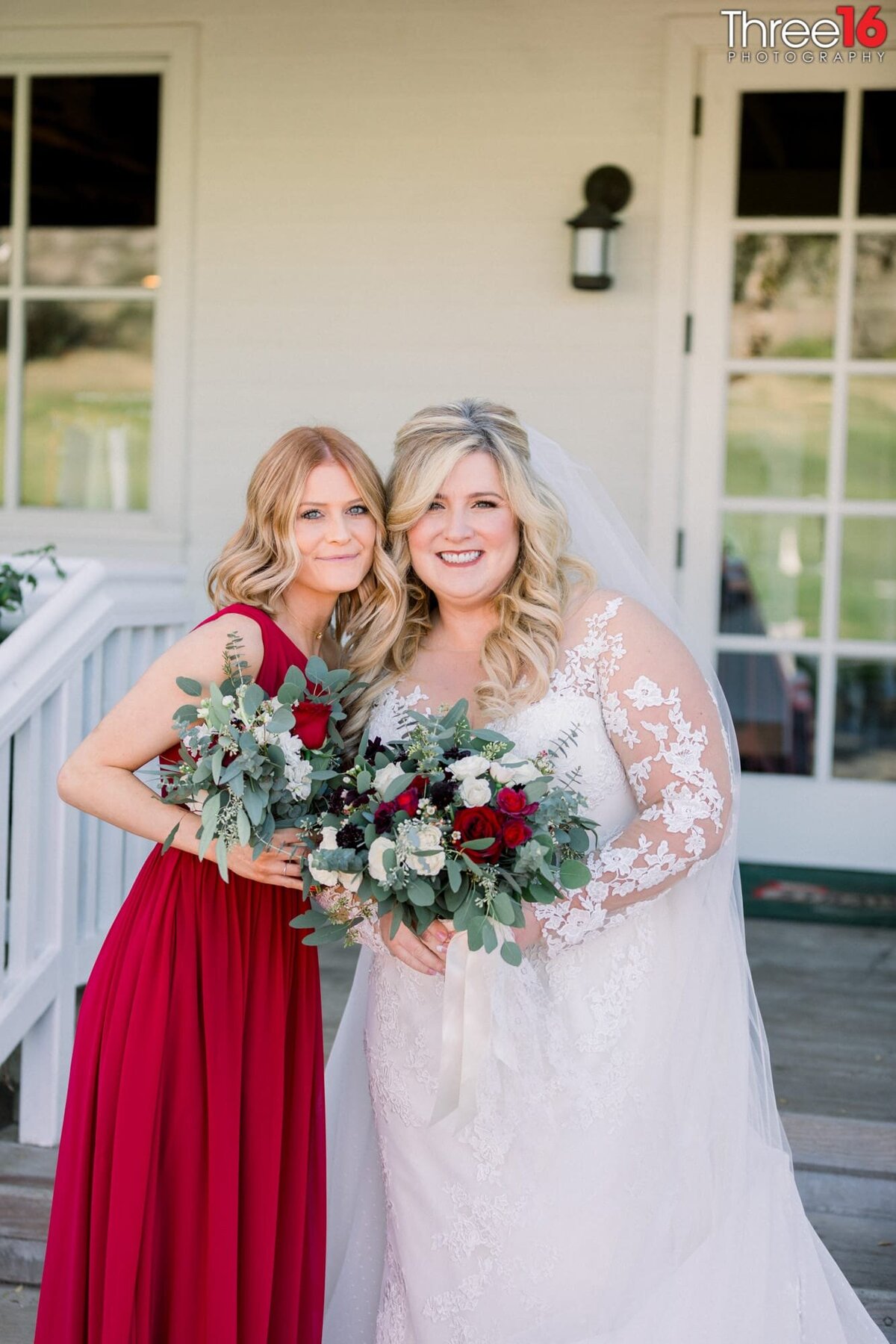 Bride poses with a Bridesmaid for photos