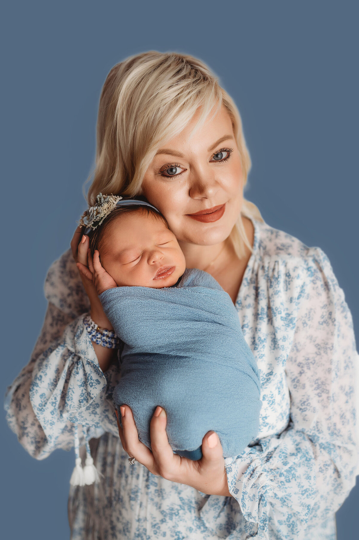 Mother embraces her baby during Newborn Photoshoot in Charleston.