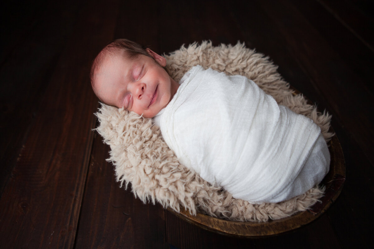 Newborn Baby Boy Wrapped and Snuggled in Bowl