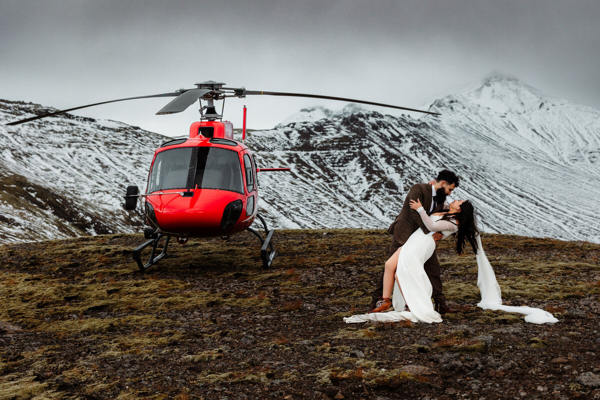 A couple kisses passionately at the edge of a dramatic Icelandic canyon, their love as deep and enduring as the ancient rock formations around them
