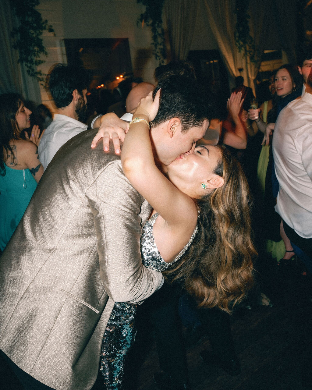 bride and groom kissing at wedding reception dancing