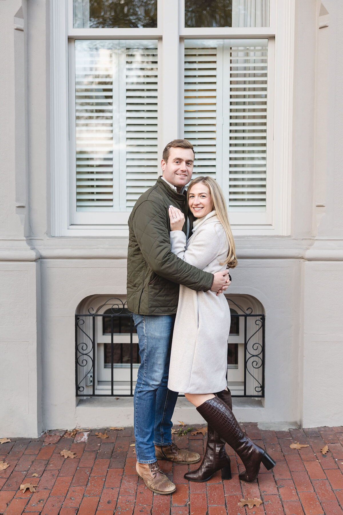 Engaged couple cuddles on the streets of Beacon Hill