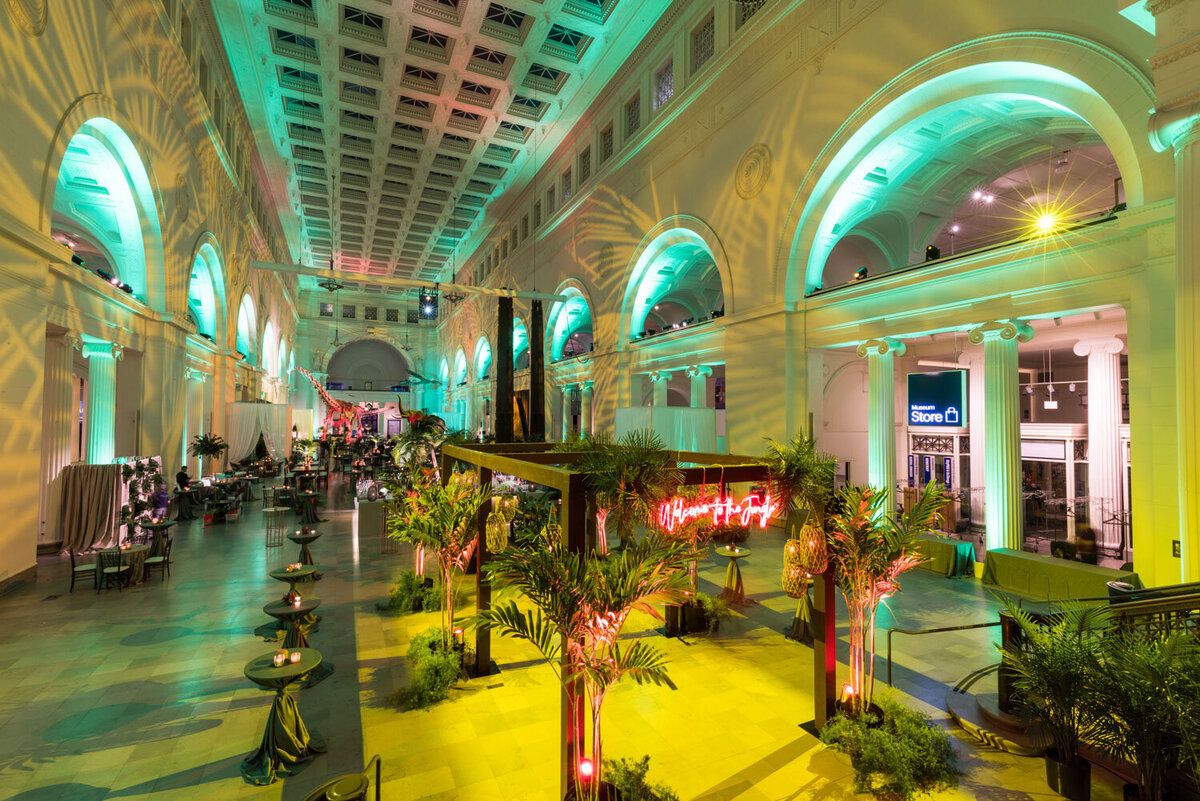 Grand hall with green lighting and tropical décor setup