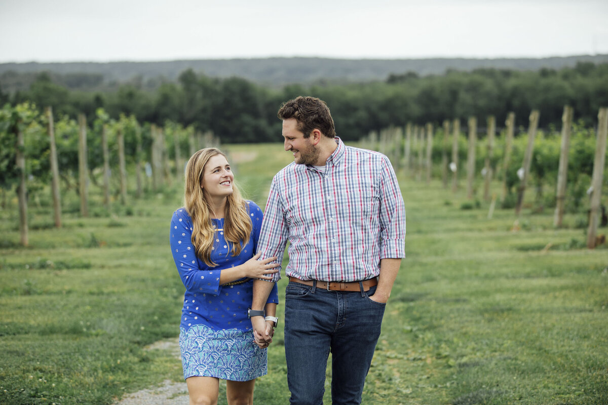 Proposal Photography | Groom-to-be proposing in the vineyard at Old York Cellars surrounded by rolling hills | Ringoes, New Jersey